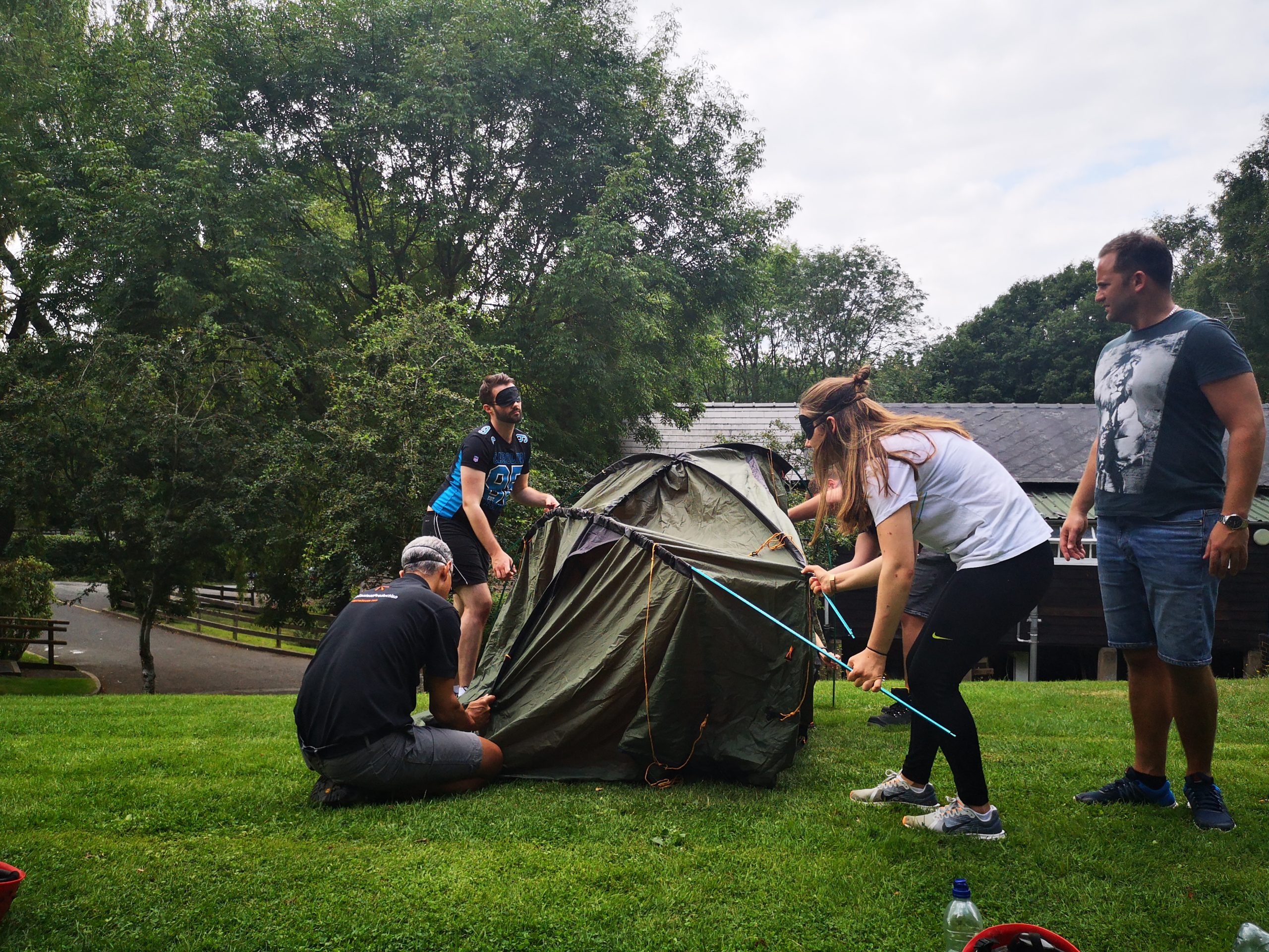Group setting up a tent