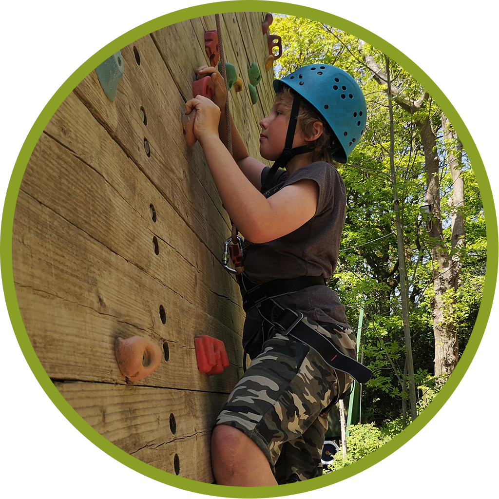 Young boy climbing a climbing wall