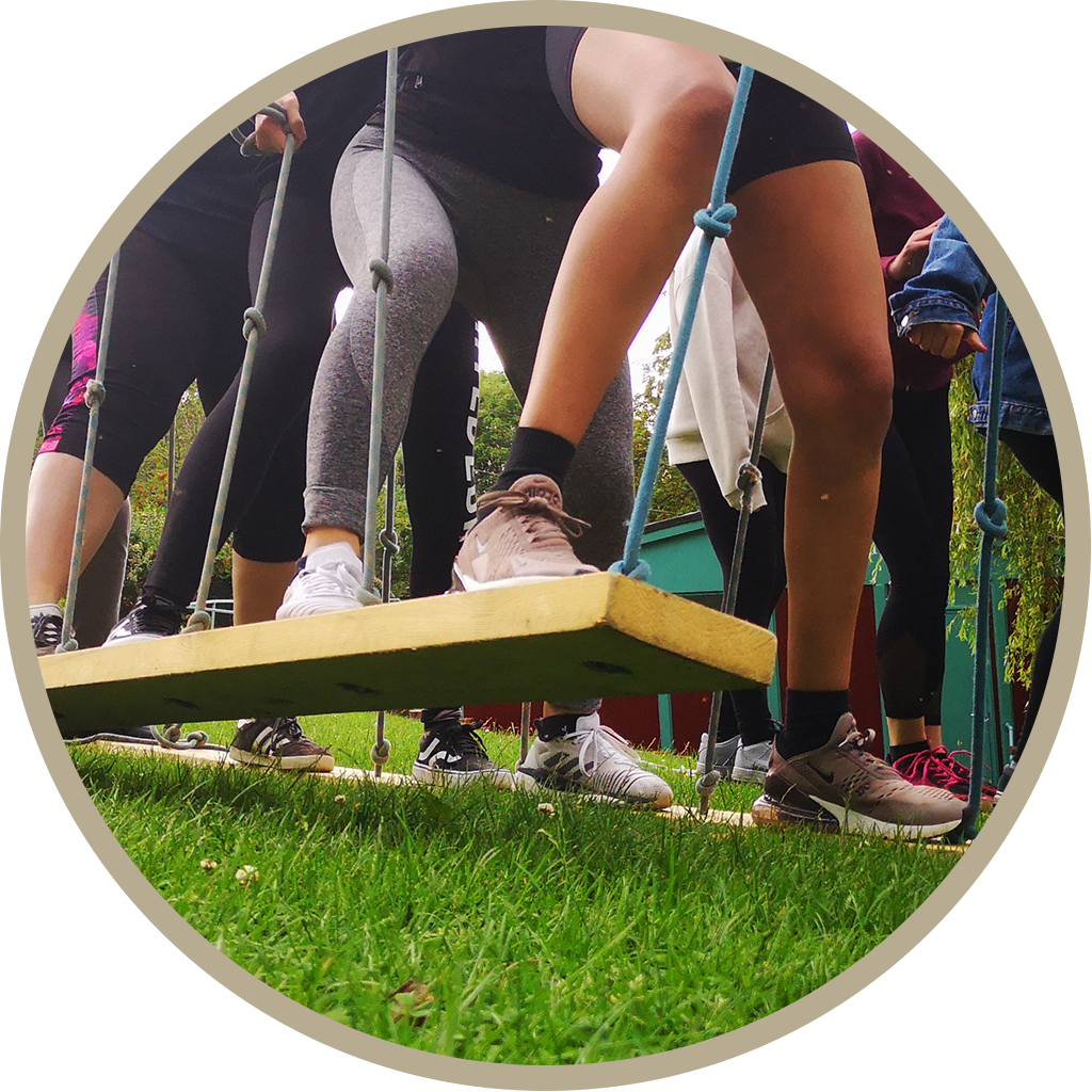 Group of people balancing on a wooden beam